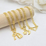 May include: Four gold chain bracelets with different charms.  Each bracelet features a delicate, layered chain design and a unique pendant: a padlock and key, a star, a crescent moon, and a heart. The charms are intricately detailed and add a touch of elegance to the simple chain design. The bracelets are displayed on a beige surface.